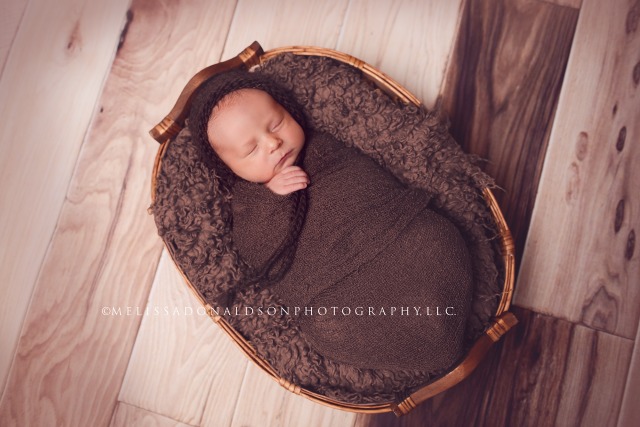 Newborn wrapped in basket
