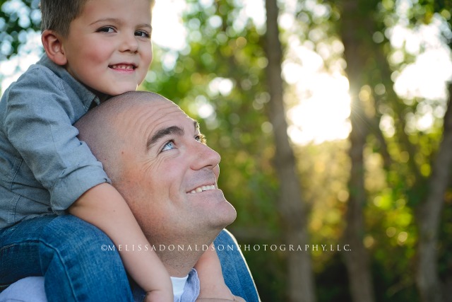 Dad and son with son on shoulders photo