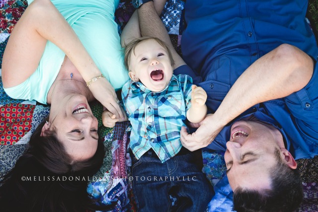 family tickling on a blanket together